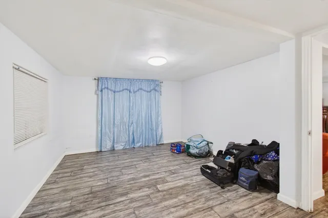 a view of a room with wooden floor and gym equipment