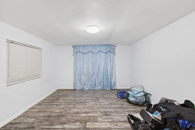 a view of a room with wooden floor and bathroom