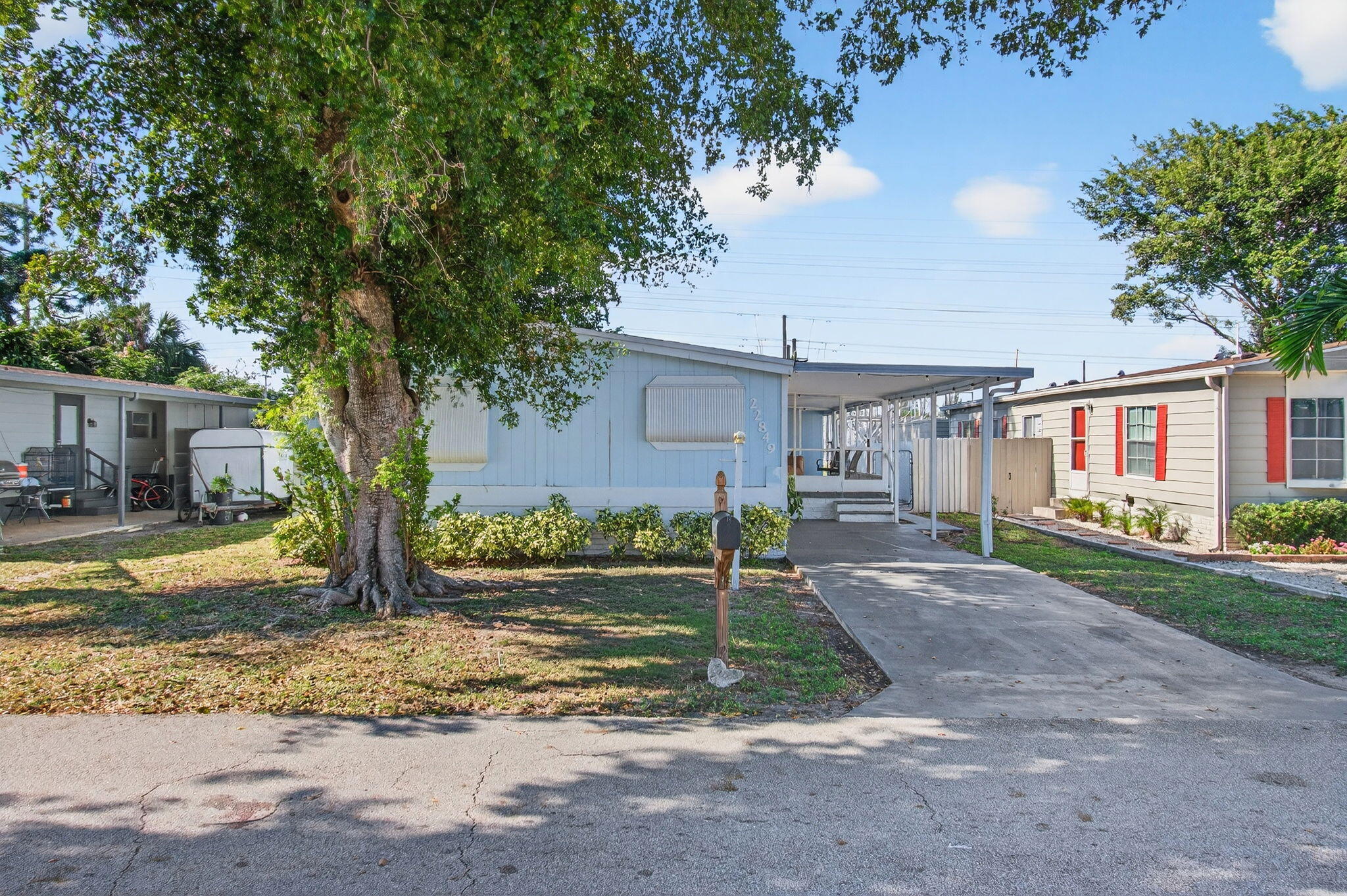 22849 Tradewind Road Boca Raton, FL 33428 - Photo 3 of 60 a view of a house with a yard