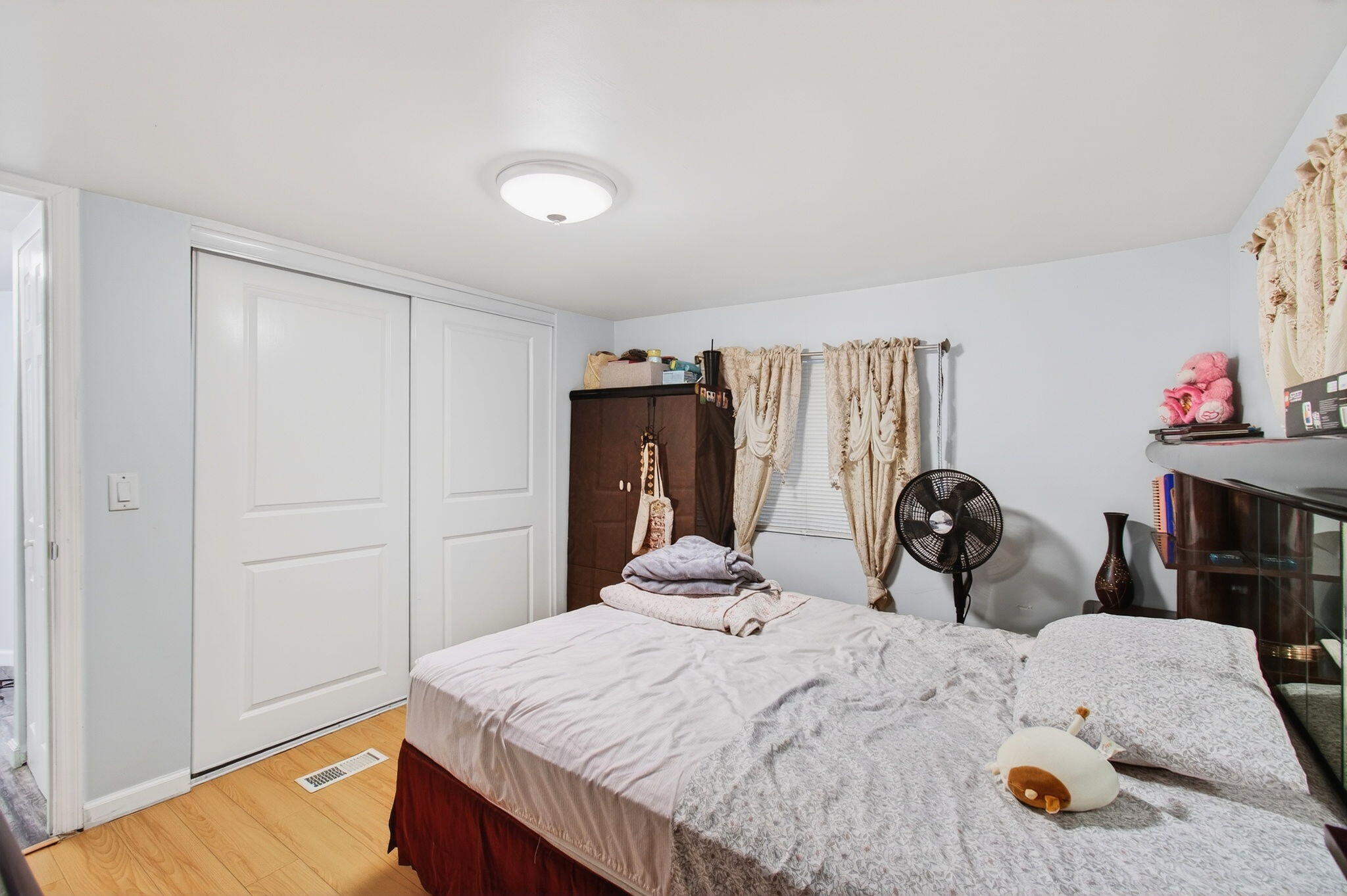 22849 Tradewind Road Boca Raton, FL 33428 - Photo 38 of 60 a bedroom with a bed and wooden floor