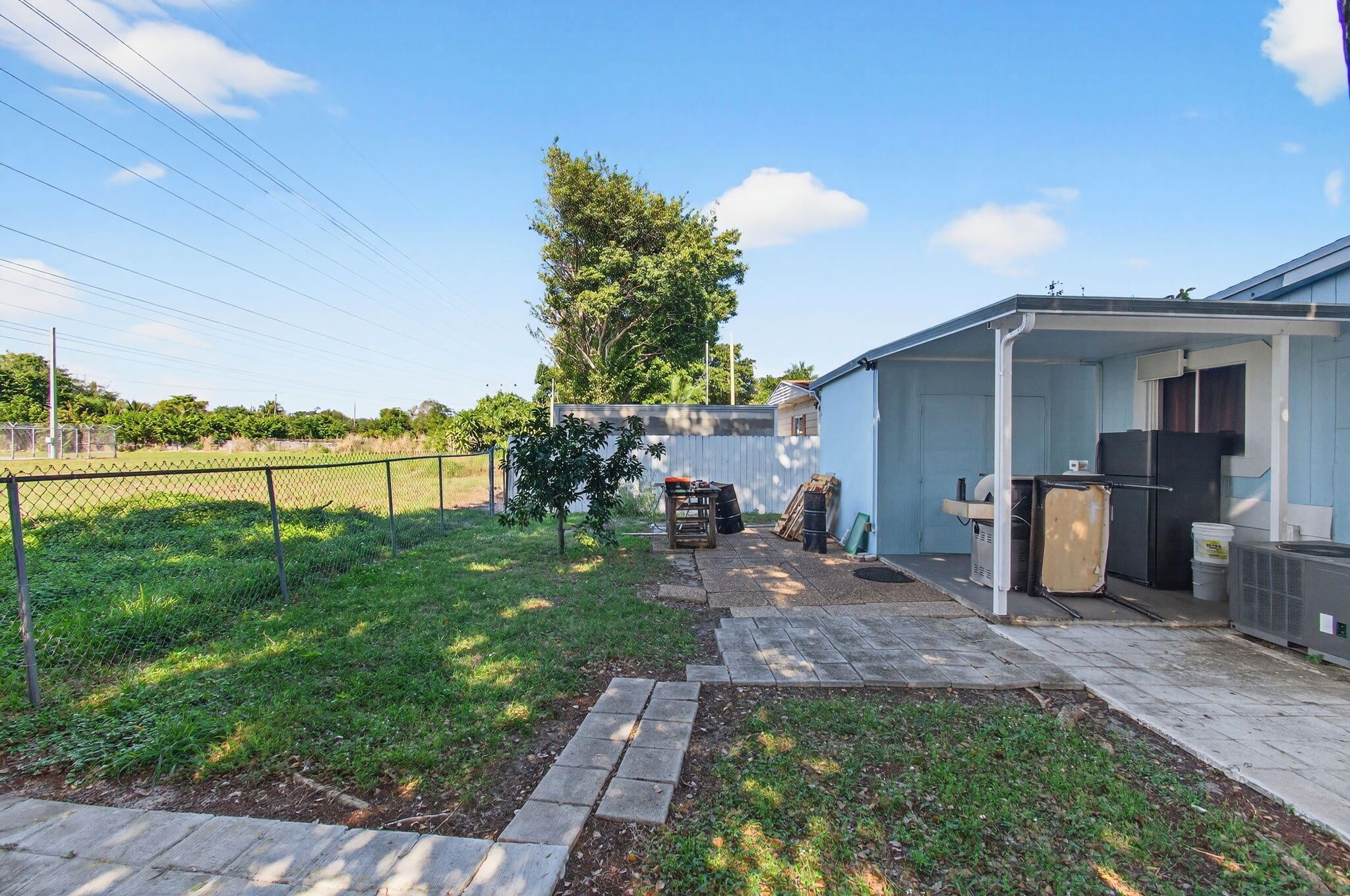 22849 Tradewind Road Boca Raton, FL 33428 - Photo 56 of 60 a view of a backyard with plants and a patio