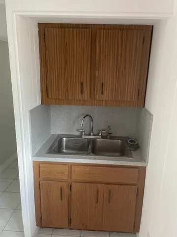 a kitchen with a sink and cabinets