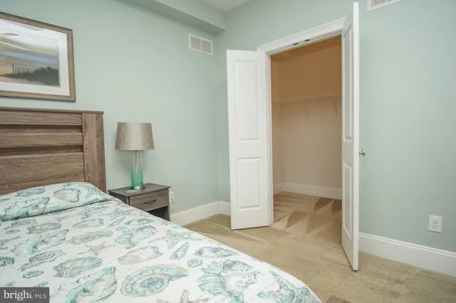a bedroom with a bed and a mirror