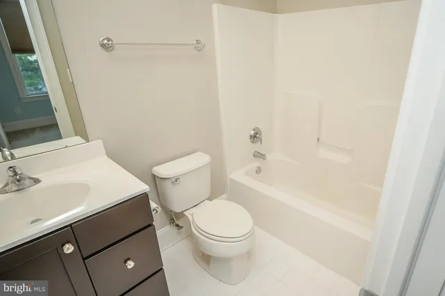 a white toilet sitting next to a bathroom sink