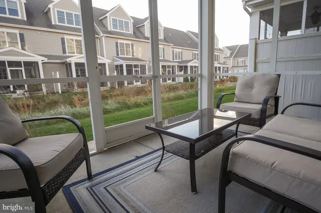 a view of a balcony with two chairs and a table