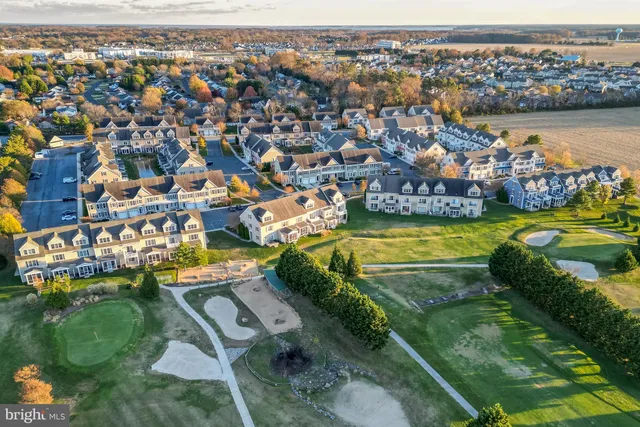 an aerial view of a city with a lake view