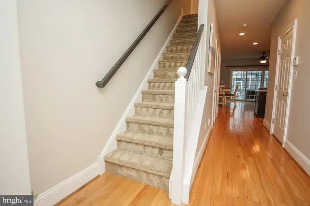a view of entryway with wooden floor and stairs