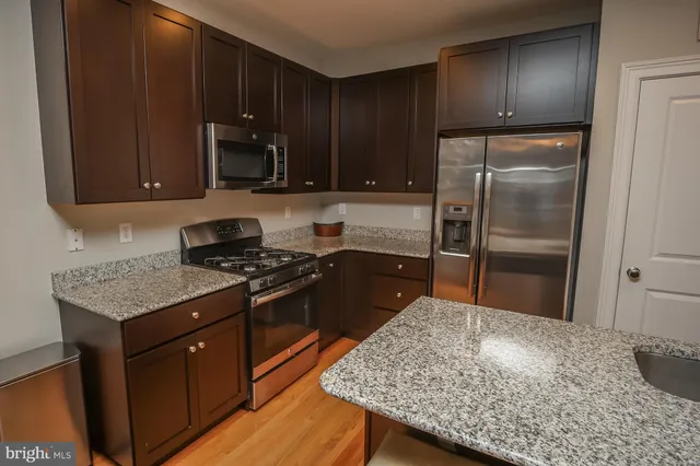a kitchen with a sink stove and refrigerator