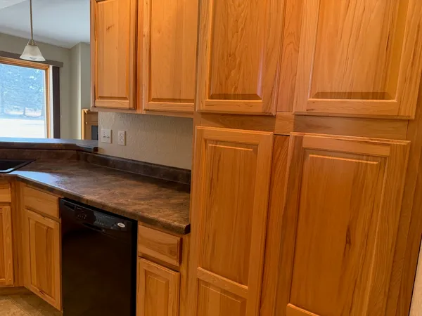 an empty room with a window and a ceiling fan