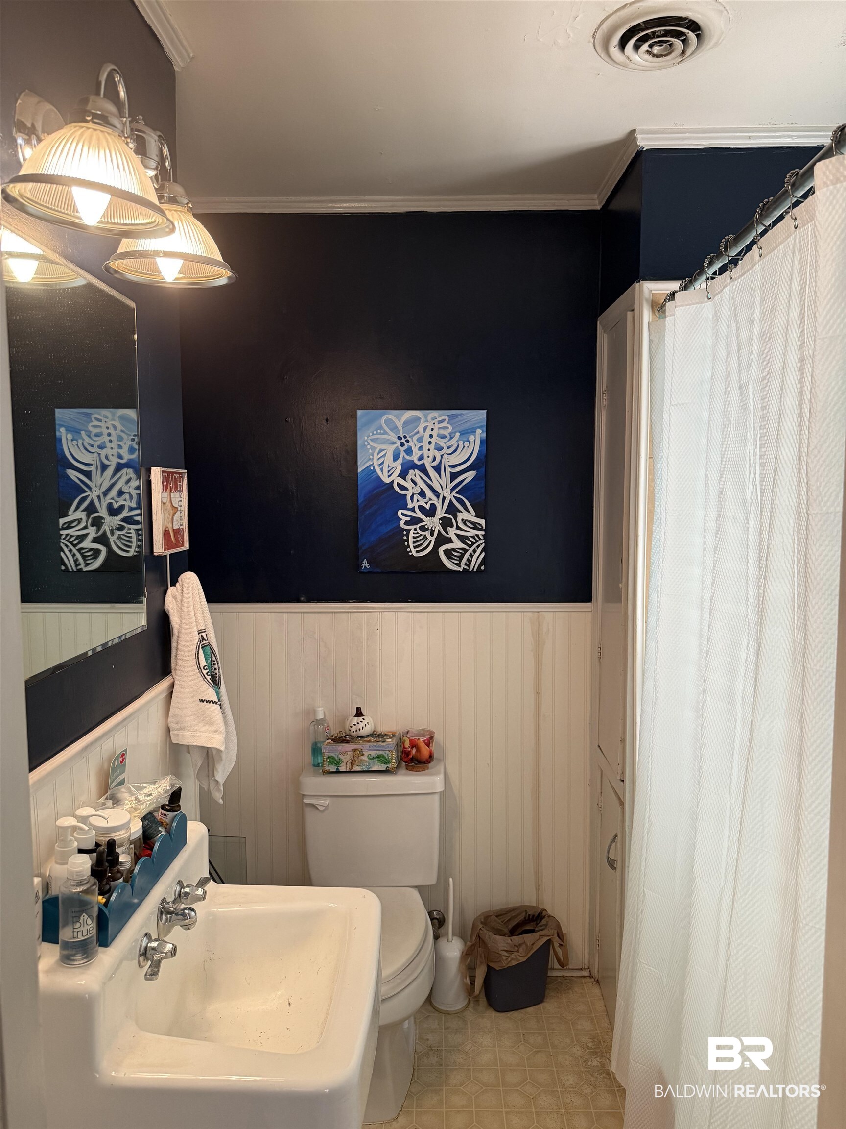 22173 1st Street Silverhill, AL 36576 - Photo 9 of 16 Full bathroom featuring ornamental molding, a shower with curtain, and wainscoting