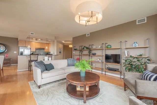 a living room with furniture and a chandelier