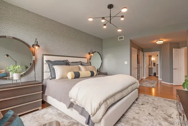 a bedroom with double bed and a chandelier