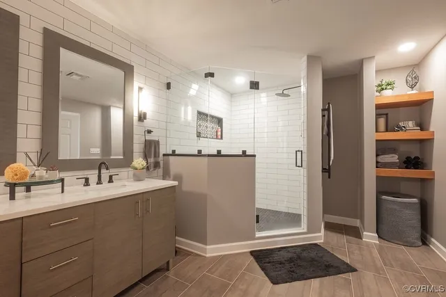 a bathroom with a sink a toilet and shower