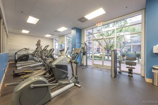 a room with gym equipment and a large window