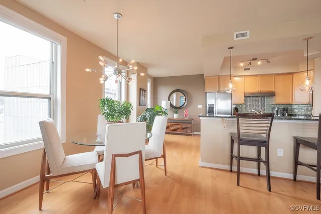 a view of a dining room with furniture and a chandelier