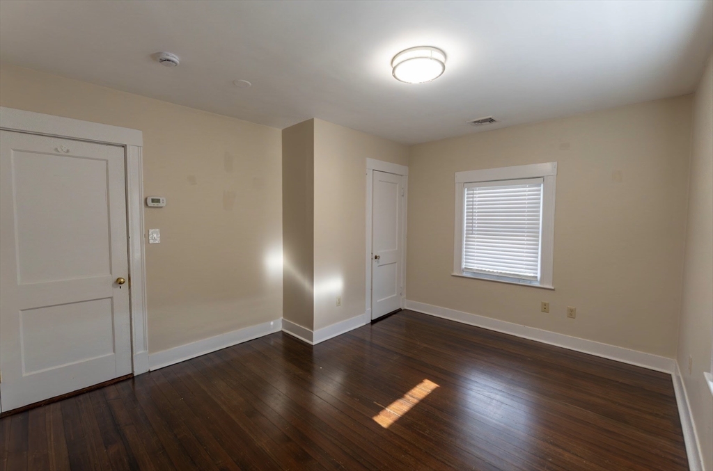 1000 South Street Boston, MA 02131 - Photo 16 of 22 an empty room with wooden floor and windows
