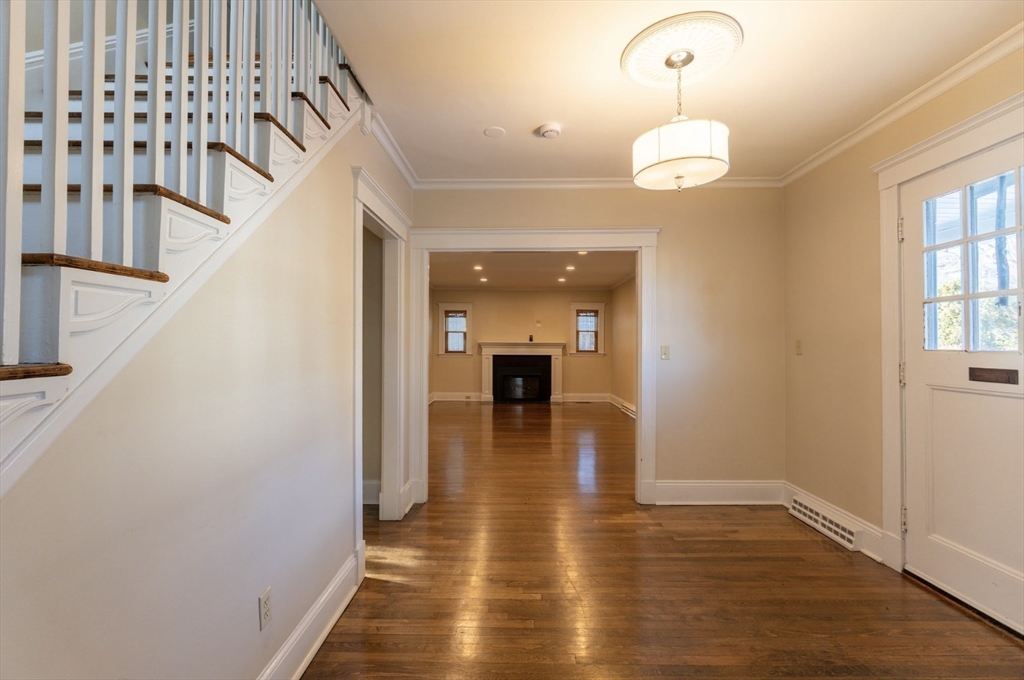 1000 South Street Boston, MA 02131 - Photo 4 of 22 a view of a hallway view with wooden floor and staircase