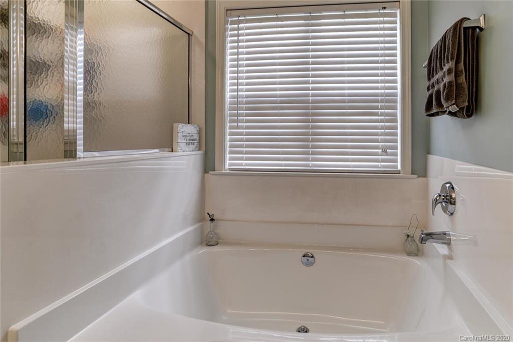30 Morning Mist Road, Unit 78 Fletcher, NC 28732 - Photo 22 of 31 a bathroom with a bathtub and a window