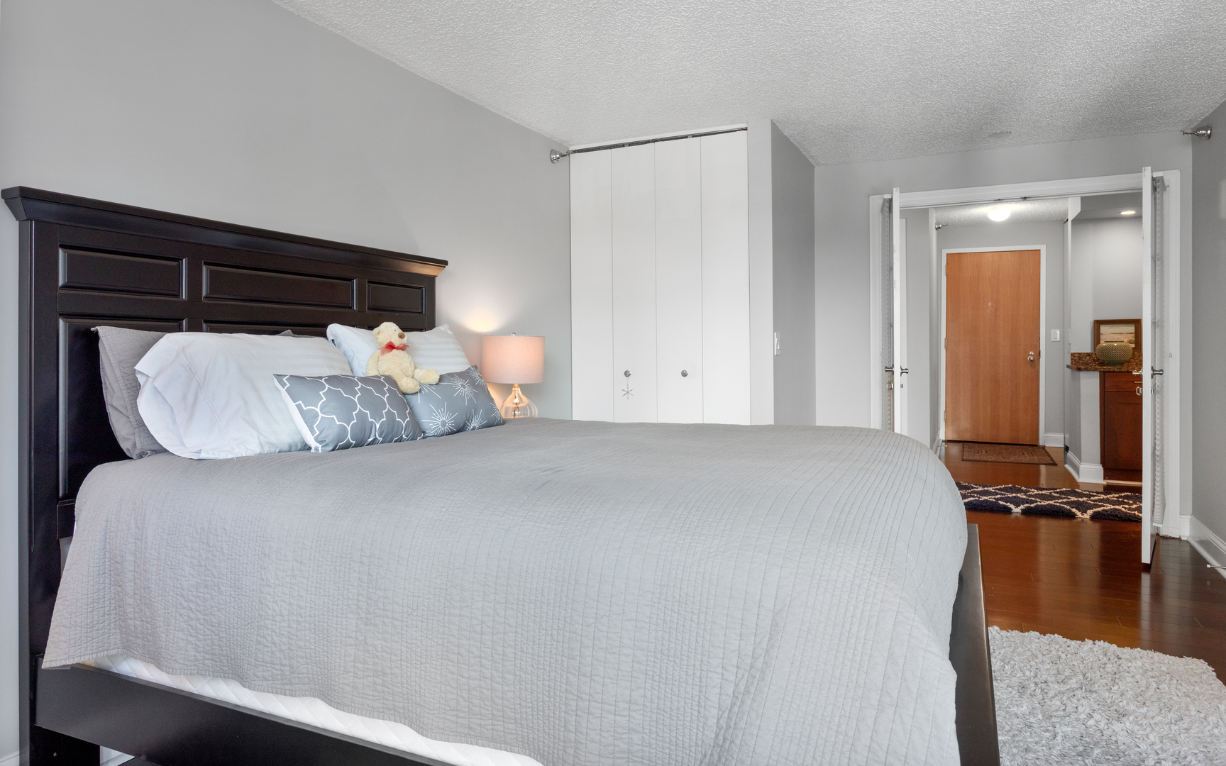 1122 North Clark Street, Unit 1808 Chicago, IL 60610 - Photo 13 of 31 a bed sitting in a bedroom next to a window