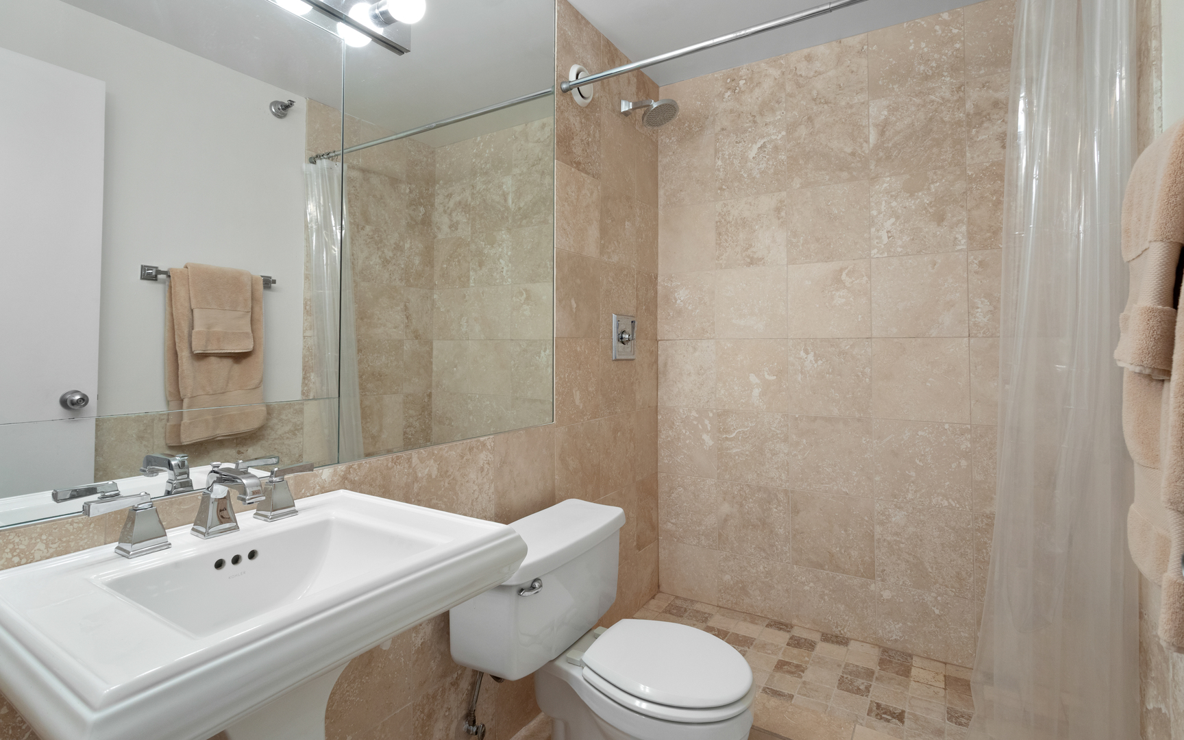 1122 North Clark Street, Unit 1808 Chicago, IL 60610 - Photo 14 of 31 a bathroom with a sink toilet a mirror and shower