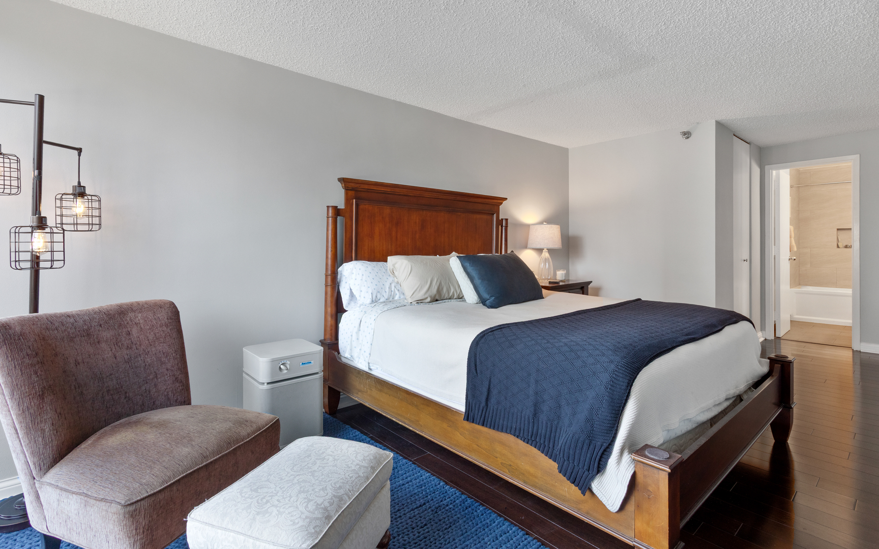 1122 North Clark Street, Unit 1808 Chicago, IL 60610 - Photo 17 of 31 a bedroom with a bed and a couch