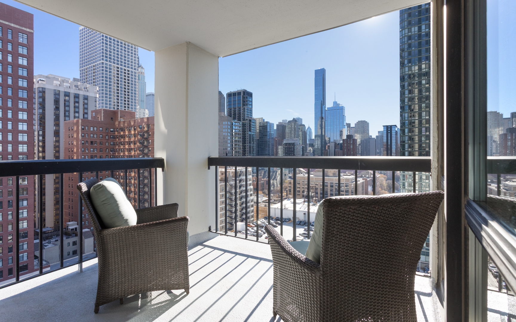1122 North Clark Street, Unit 1808 Chicago, IL 60610 - Photo 19 of 31 a view of a balcony with chair and glass door