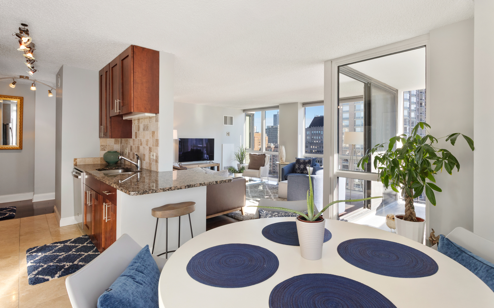 1122 North Clark Street, Unit 1808 Chicago, IL 60610 - Photo 7 of 31 a view of a dining room with furniture and wooden floor