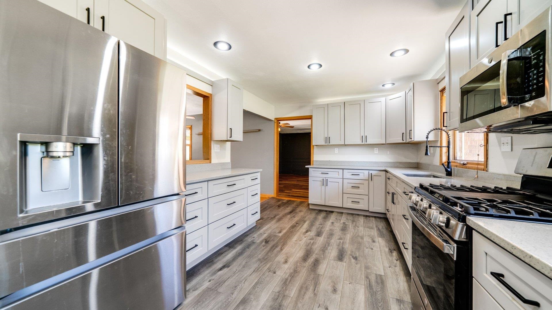 313 West Margaret Fuller Road Oregon, IL 61061 - Photo 5 of 46 a kitchen with stainless steel appliances a refrigerator sink and microwave
