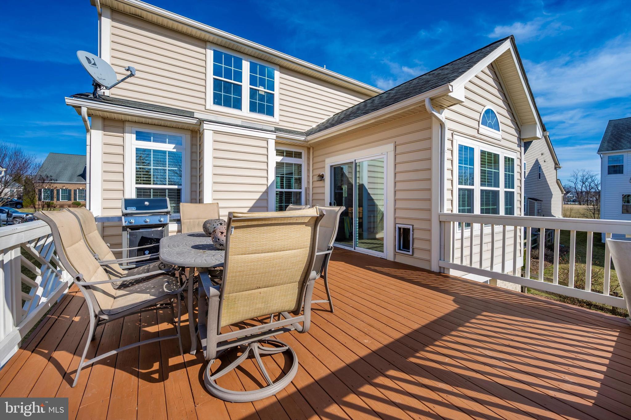 9121 Bealls Farm Road Frederick, MD 21704 - Photo 45 of 63 a view of a patio with table and chairs with wooden floor and fence