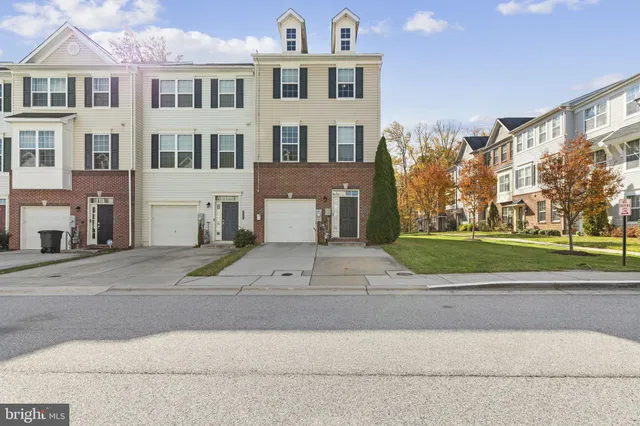 a view of a white building among the street and a building