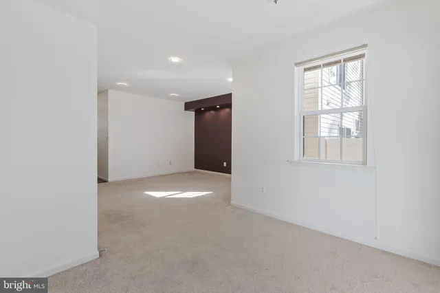 an empty room with windows and closet