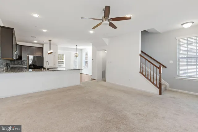 a view of an empty room with kitchen appliances and a window