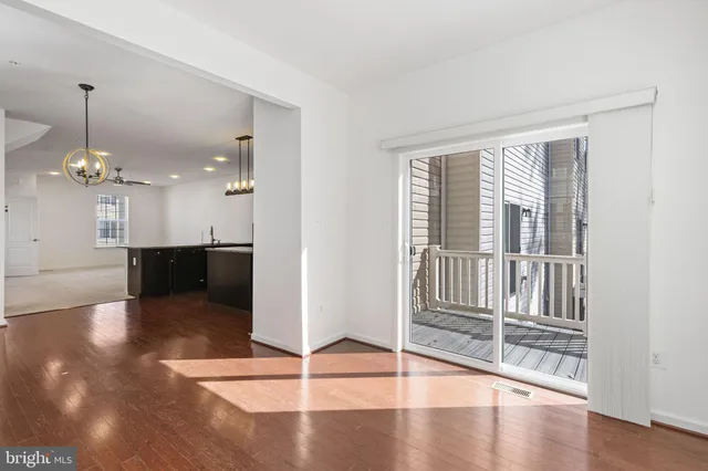 a view of a livingroom with a furniture wooden floor and windows