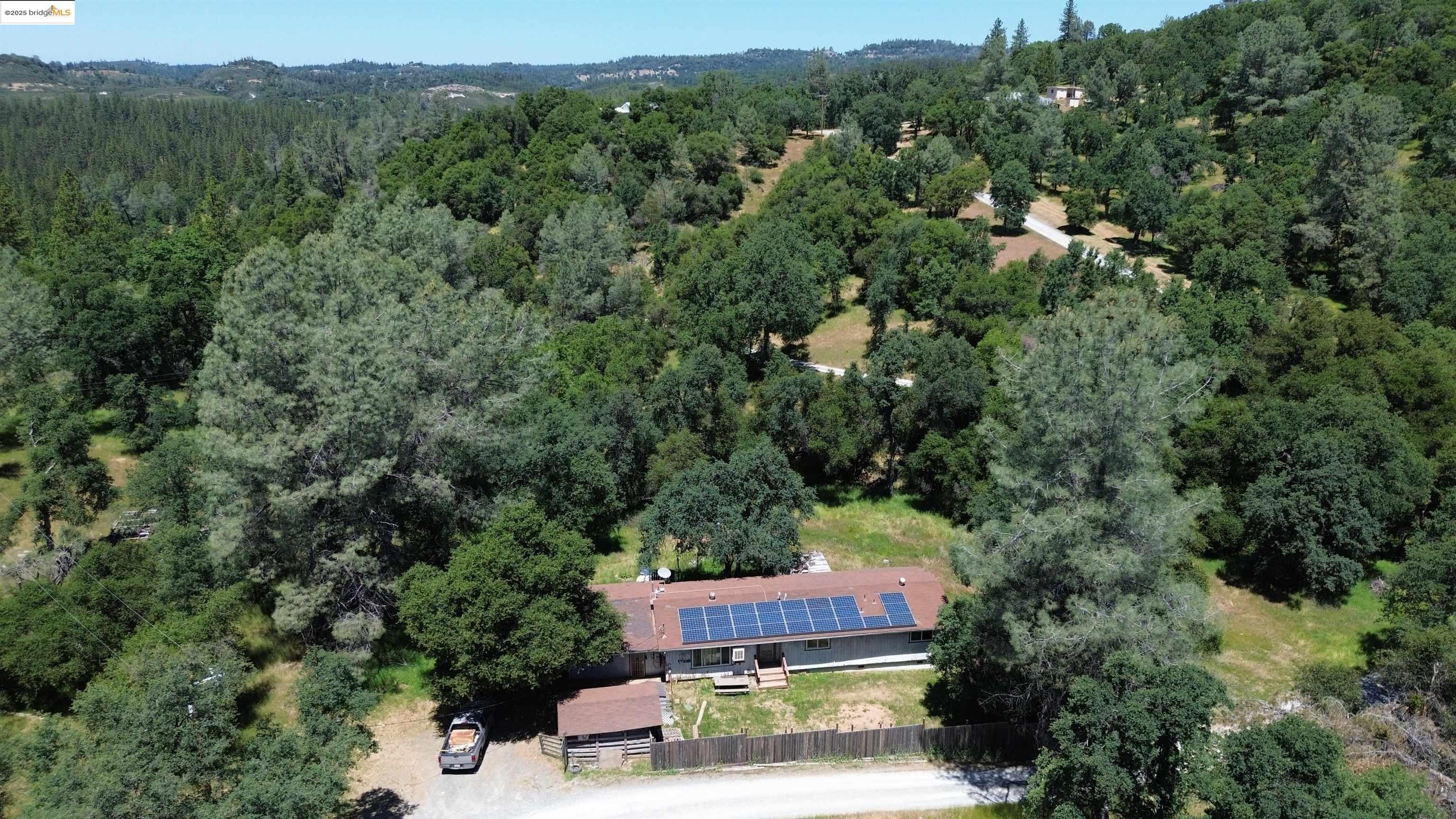 6689 Miller Ranch Road Mountain Ranch, CA 95246 - Photo 1 of 1 an aerial view of a house with a yard