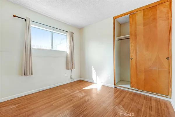 an empty room with wooden floor and a window