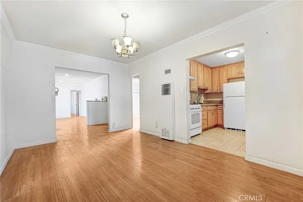 a view of a kitchen with a sink and refrigerator