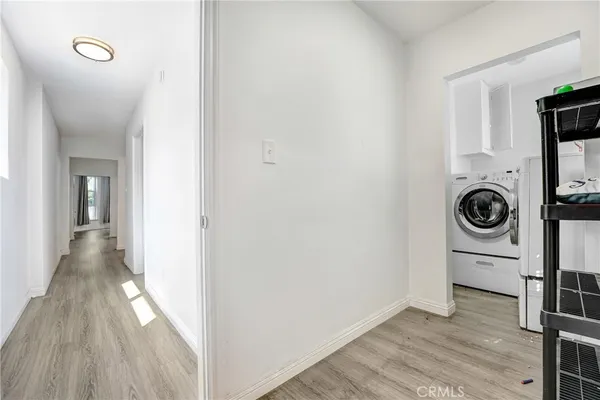 a view of a hallway with washer and dryer