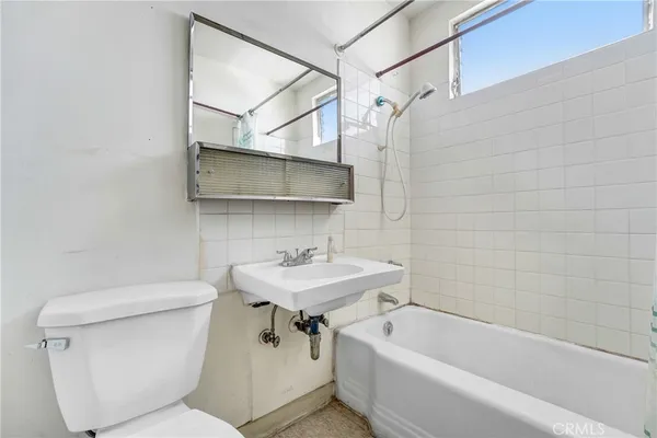 a bathroom with a sink a toilet and bathtub