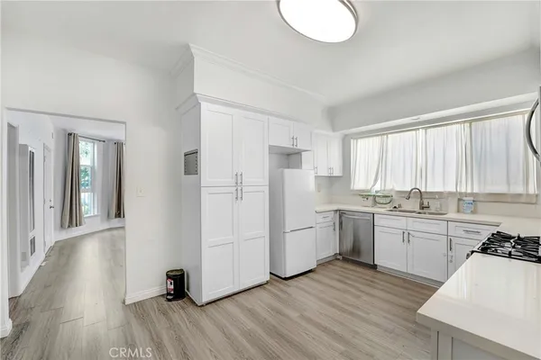 a kitchen with refrigerator and window