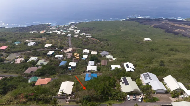 an aerial view of residential houses with outdoor space and street view