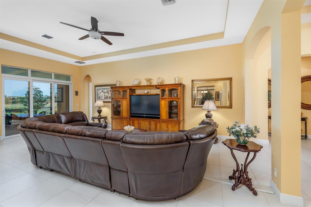 21864 Southwest Tivolo Way Port St. Lucie, FL 34986 - Photo 11 of 40 a living room with furniture and a flat screen tv