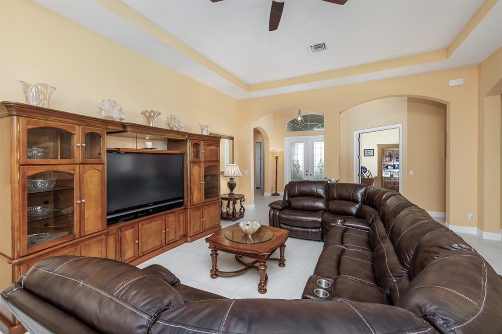21864 Southwest Tivolo Way Port St. Lucie, FL 34986 - Photo 12 of 40 a living room with furniture and a flat screen tv