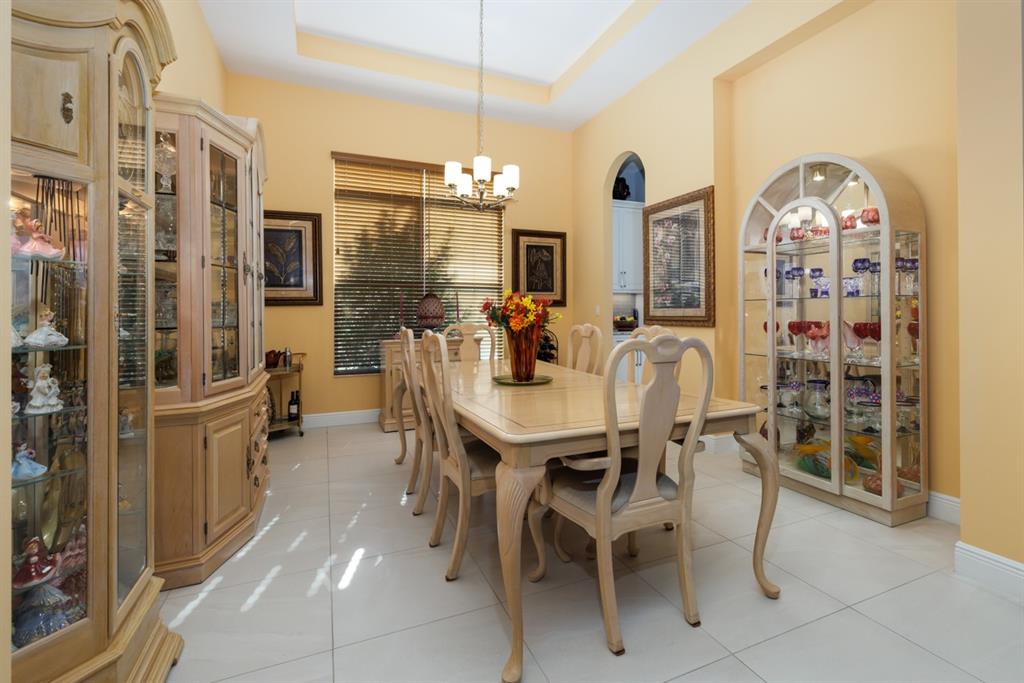 21864 Southwest Tivolo Way Port St. Lucie, FL 34986 - Photo 13 of 40 a view of a dining room with furniture and chandelier