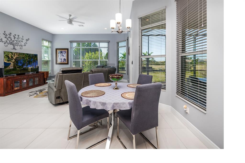 21864 Southwest Tivolo Way Port St. Lucie, FL 34986 - Photo 20 of 40 a view of a dining room with furniture window and wooden floor