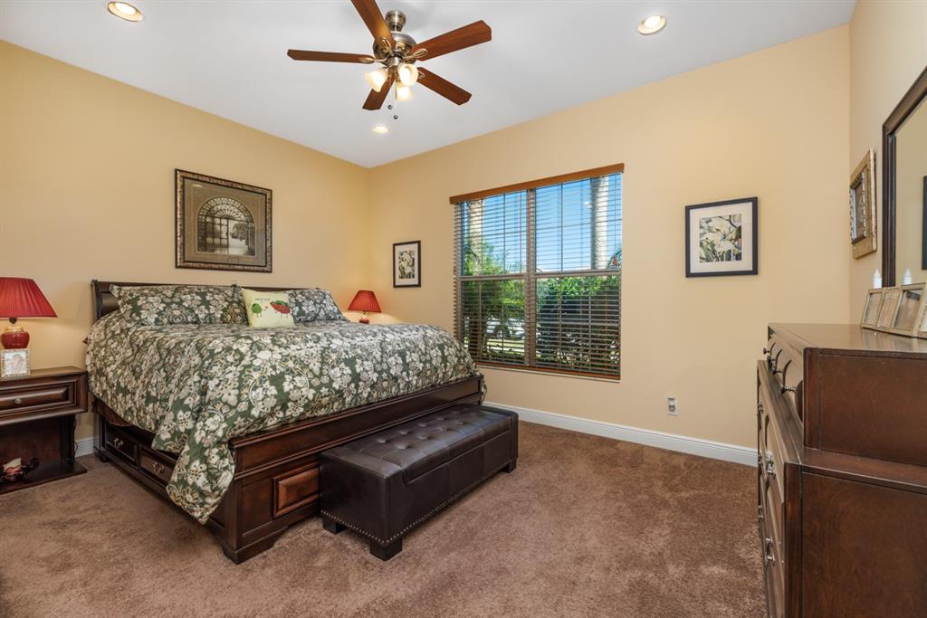 21864 Southwest Tivolo Way Port St. Lucie, FL 34986 - Photo 23 of 40 a bedroom with a bed and a window