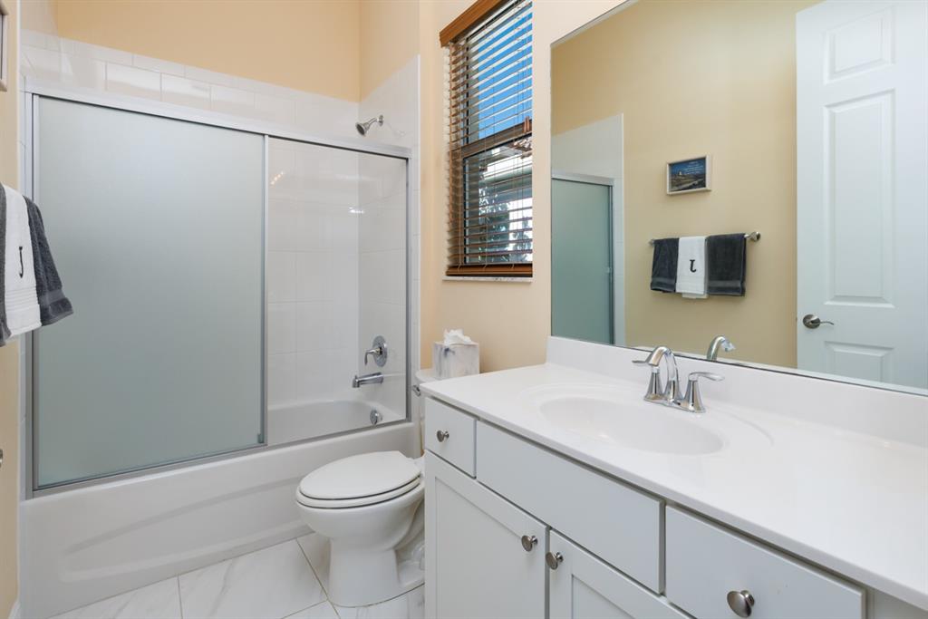 21864 Southwest Tivolo Way Port St. Lucie, FL 34986 - Photo 24 of 40 a bathroom with a sink a toilet and shower