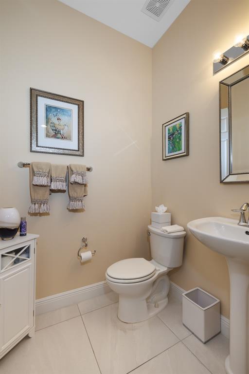 21864 Southwest Tivolo Way Port St. Lucie, FL 34986 - Photo 27 of 40 a bathroom with a toilet sink and mirror