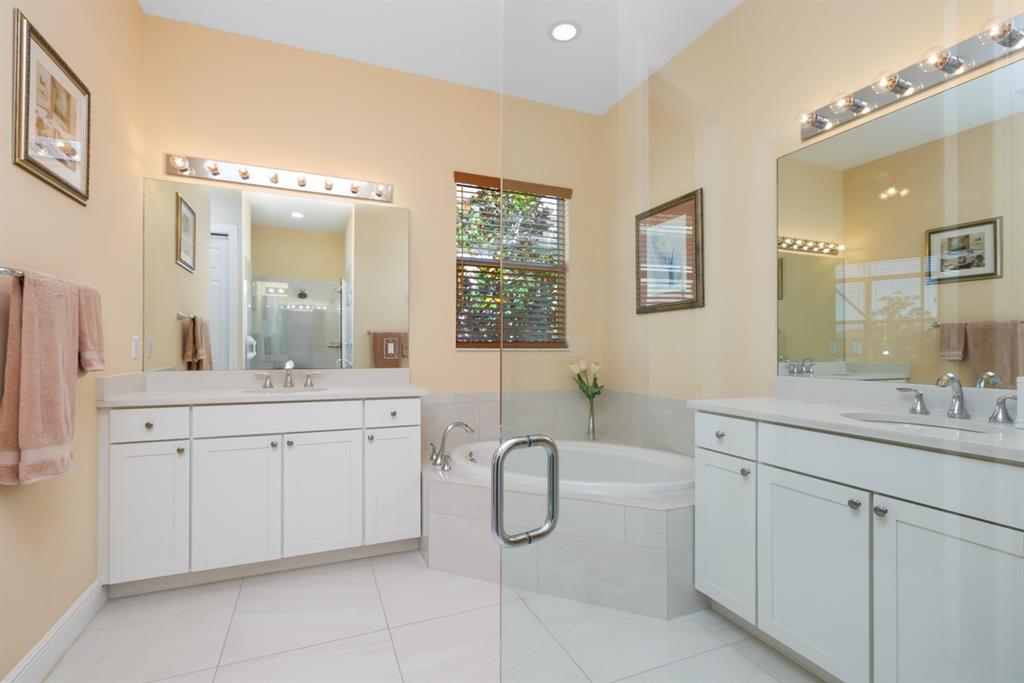 21864 Southwest Tivolo Way Port St. Lucie, FL 34986 - Photo 29 of 40 a spacious bathroom with a granite countertop sink mirror and bathtub