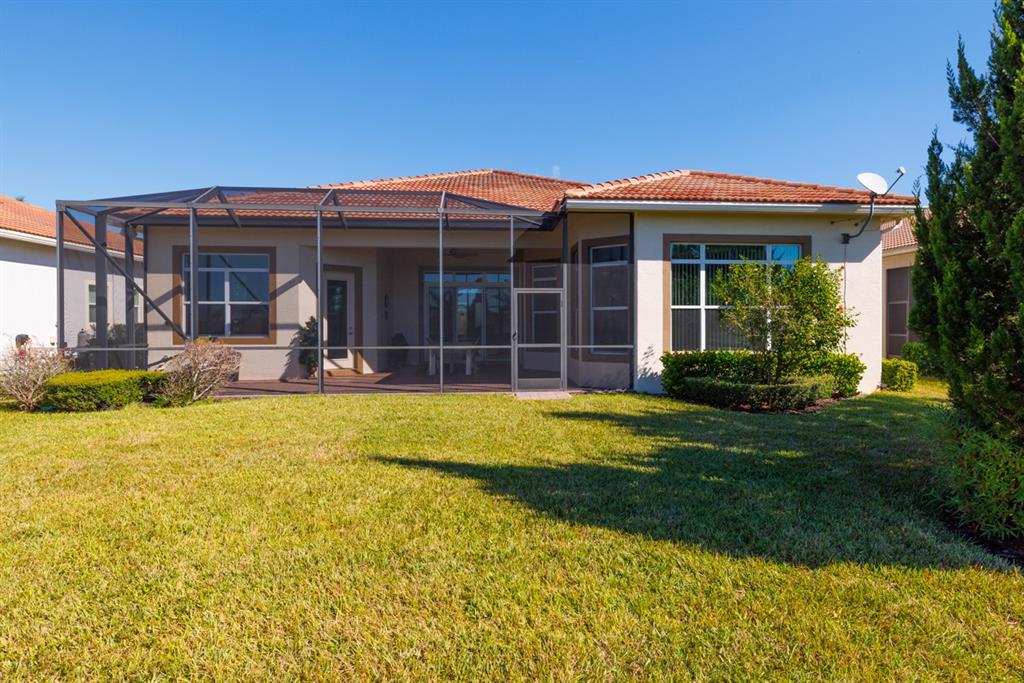 21864 Southwest Tivolo Way Port St. Lucie, FL 34986 - Photo 38 of 40 front view of a house with a yard