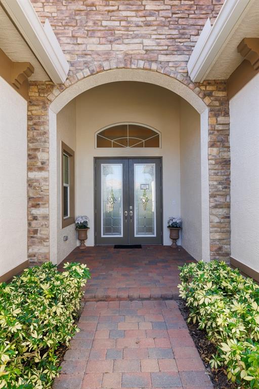 21864 Southwest Tivolo Way Port St. Lucie, FL 34986 - Photo 6 of 40 a front view of a house with garden